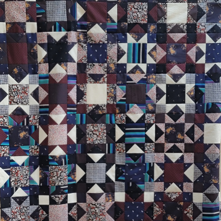a throw sized quilt using shirts and the sawtooth star block