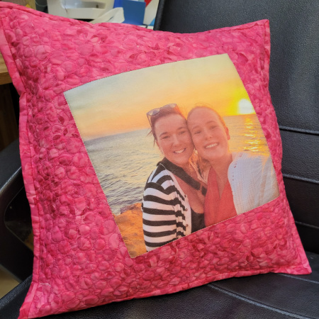 A photo memory cushion using a photo of mother and daughter, bordered with pink fabric and featuring free motion quilting