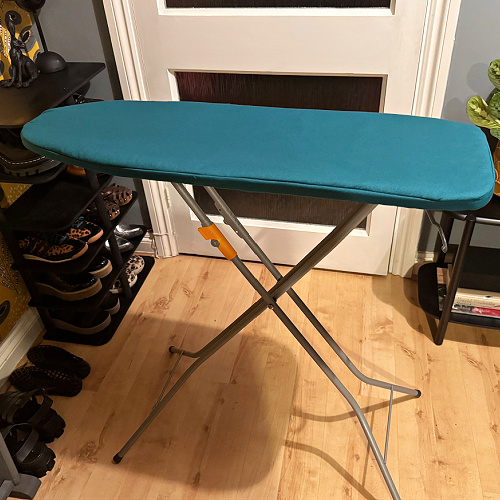 Bespoke cover for a smaill ironing board using customers own fabric in teal 